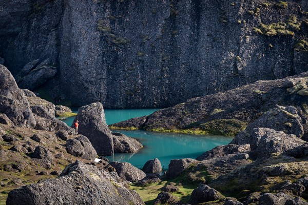 Man standing at turquoise water pool