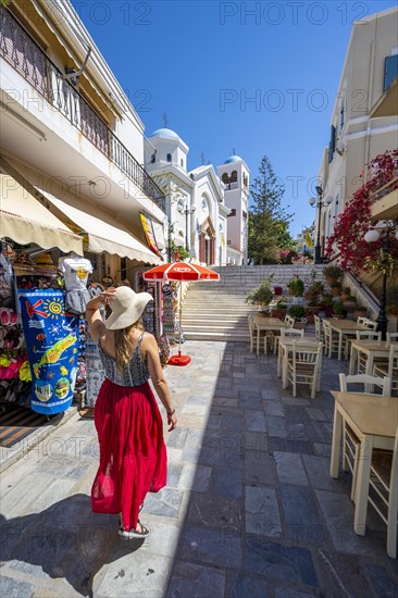 Young woman with dress walking through pedestrian zone