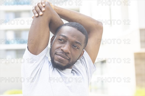 Young black man doing fitness in the summer of the city