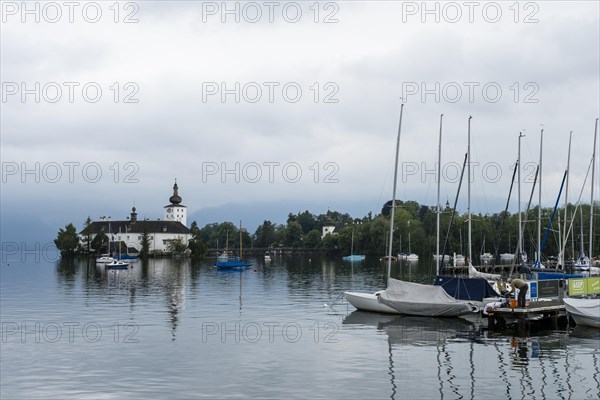 Orth Castle on Lake Traun in Gmunden and boats in the harbour