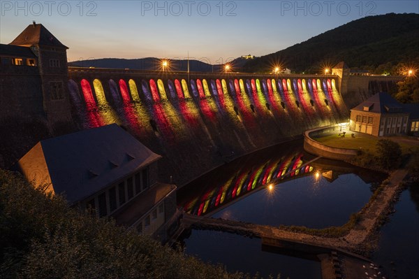 Illuminated dam wall in the evening twilight