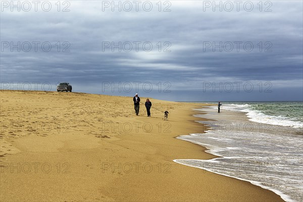 Walkers at the empty beach