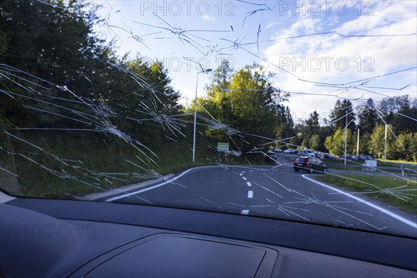 Shattered windscreen due to hailstones on a car