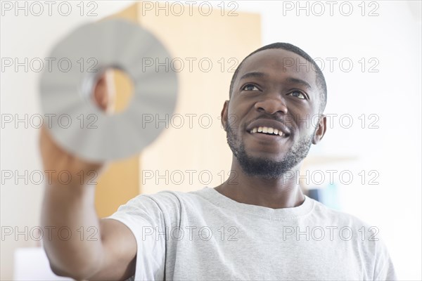 Young black man holding an idea as an invention