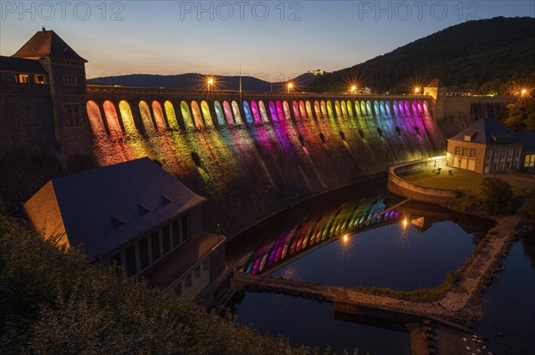 Illuminated dam wall in the evening twilight