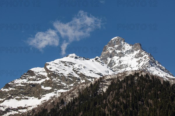 Snowcapped mountains against blue sky