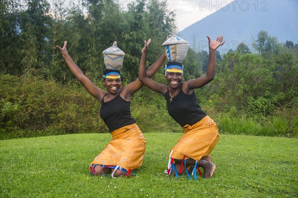 Woman carrying a basket on her hat at a ceremony of former poachers