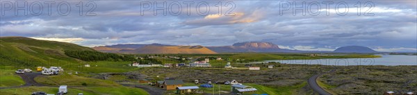 Camping site and church of Reykjahlio Myvatn with ash crater Hverfjall in the evening light