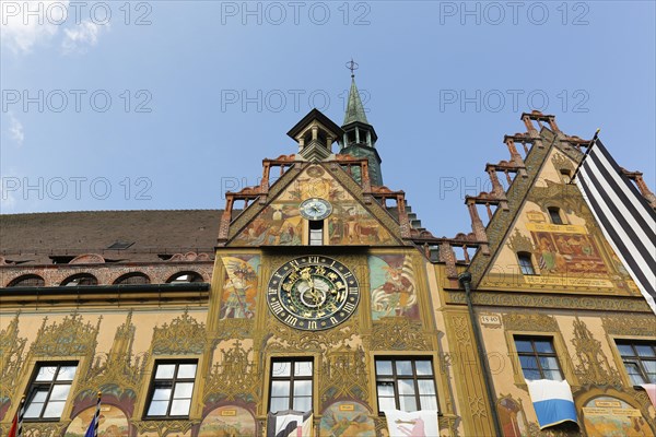 Richly decorated astronomical clock with signs of the zodiac on the town hall