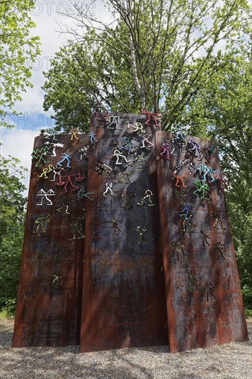 Three steel slabs with colourful figures