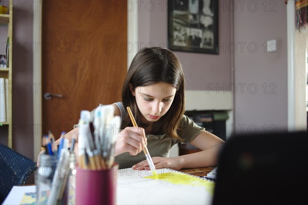 Young teenage girl painting