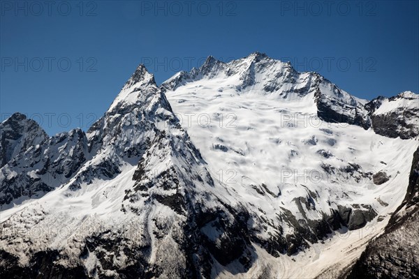 Snowcapped mountains against clear blue sky