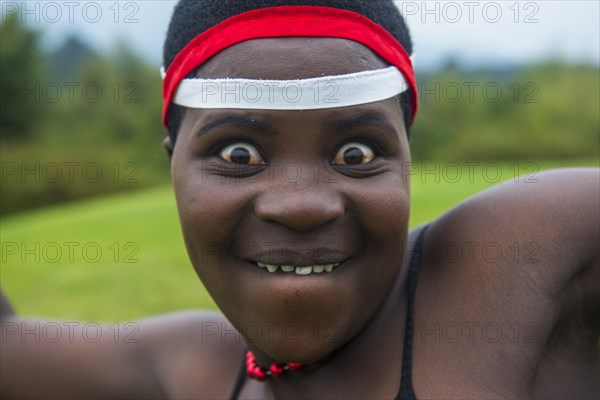 Woman starring at the camera at a ceremony of former poachers