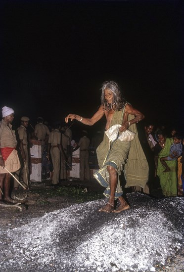 An old woman walking on burning coal