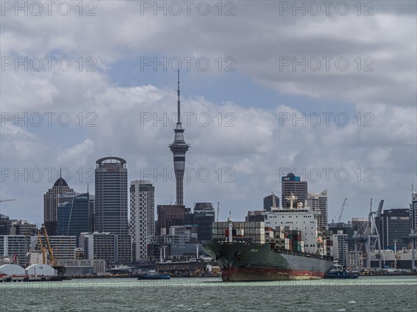 Container ship in front of the Auckland skyline