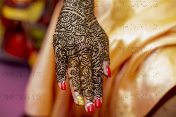 Hand of a Hindu bride painted with henna on the eve of her wedding in Beau-Bassin