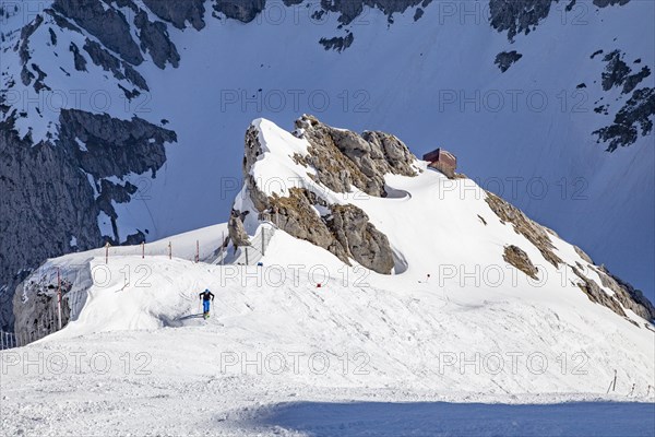 Touring skiers ascending in front of the summit slope