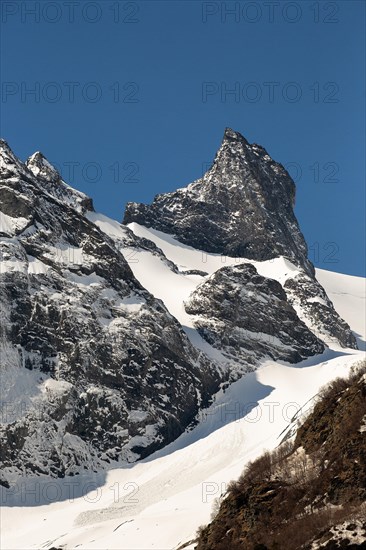 Snowcapped mountains against clear blue sky