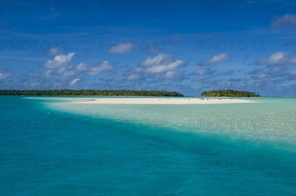 White sand beach and palm fringed beach in Aitutaki lagoon