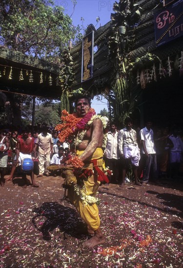 A god possessed man beating himself with whip. Mariamman festival at Coimbatore