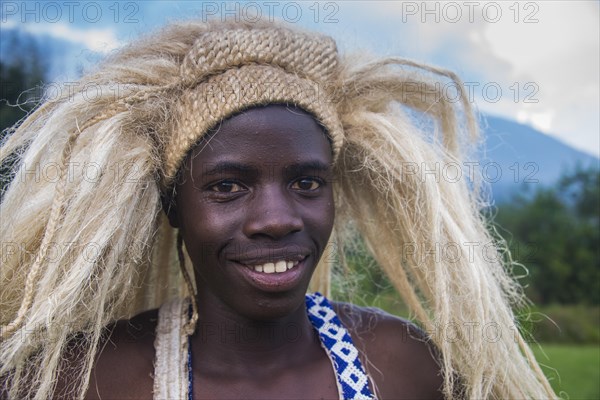 Young man with a wig on a ceremony of former poachers