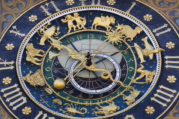 Richly decorated astronomical clock with signs of the zodiac at the town hall