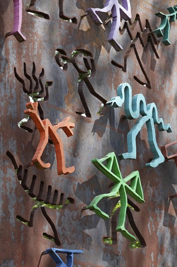 Colourful figures on a steel slab