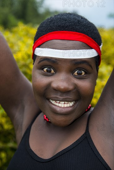 Woman starring at the camera at a ceremony of former poachers