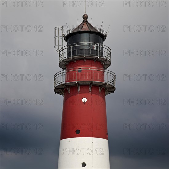 Lighthouse in front of dark clouds