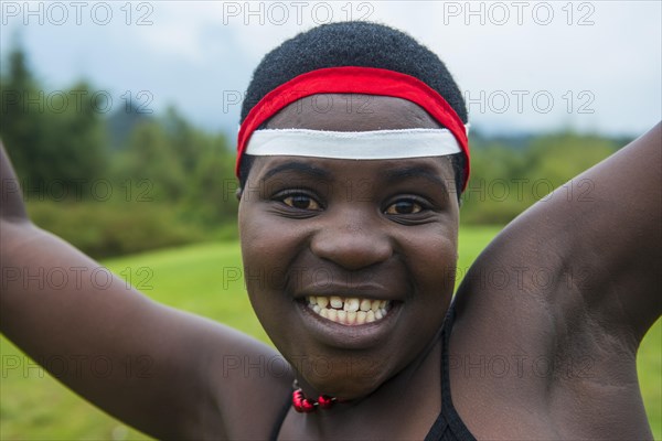 Woman starring at the camera at a ceremony of former poachers