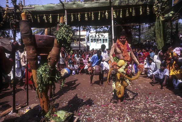 A god possessed man beating himself with whip. Mariamman festival at Coimbatore