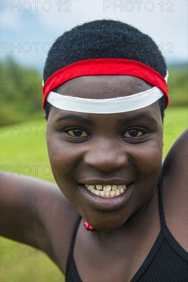 Woman starring at the camera at a ceremony of former poachers