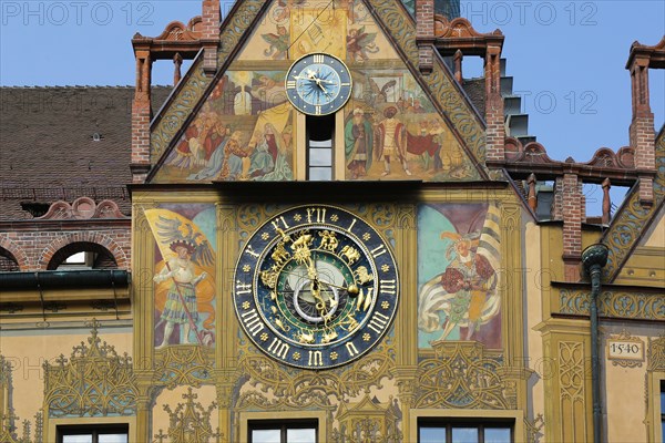 Richly decorated astronomical clock with signs of the zodiac on the town hall