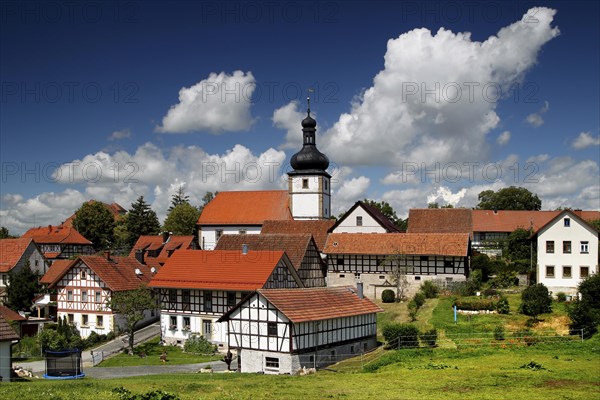 Village with half-timbered houses and church with onion-roofed tower