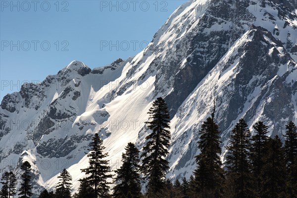 Snowcapped mountains against clear blue sky