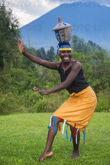 Woman carrying a basket on her hat at a ceremony of former poachers