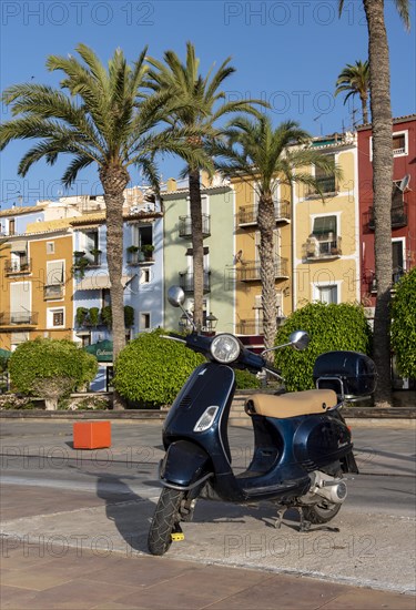 Vespa scooter in front of Colorful beachfront houses