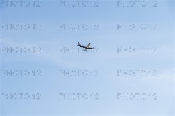 Landing small passenger airplane on blue sky