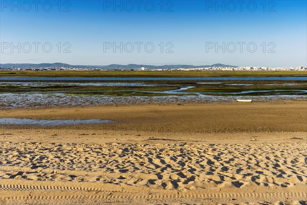 City of Faro seen from Faro Beach Peninsula with wetlands of Ria Formosa in between