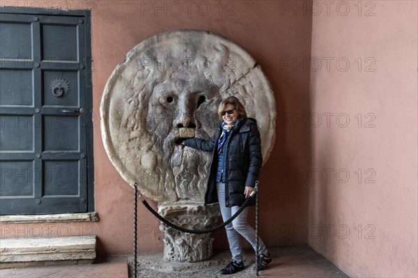 Western tourist puts hand in mouth of truth