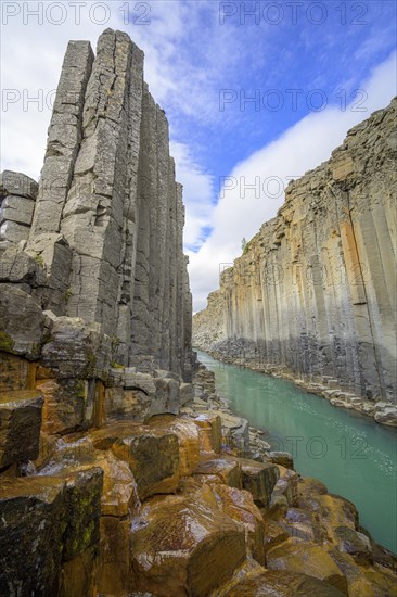 Basalt columns coloured orange by iron oxide