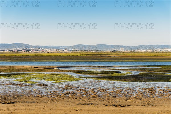 City of Faro seen from Faro Beach Peninsula with wetlands of Ria Formosa in between