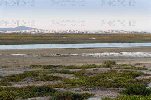 City of Faro seen from Faro Beach Peninsula with wetlands of Ria Formosa in between