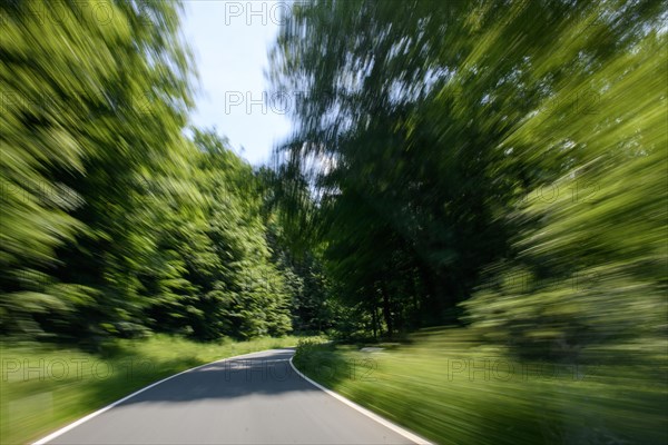 View through windscreen of moving car on winding country road