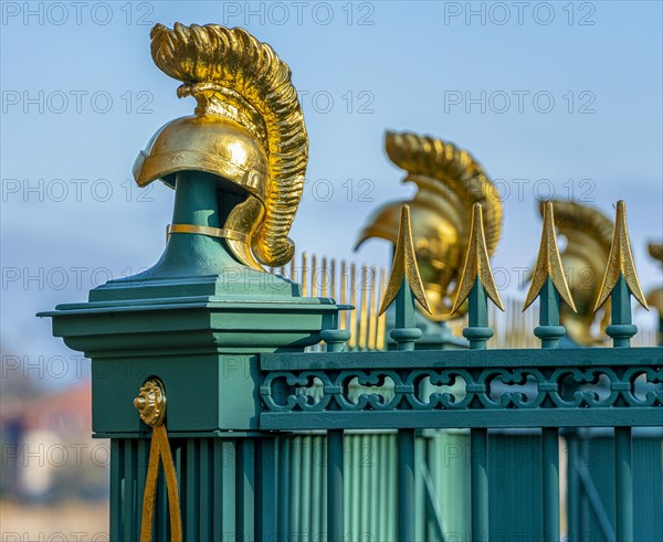 Restored fence with gold helmets at the Lake Grienerick obelisk in Rheinsberg