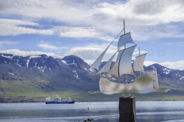 Trawler and emigrants' monument in the harbour of