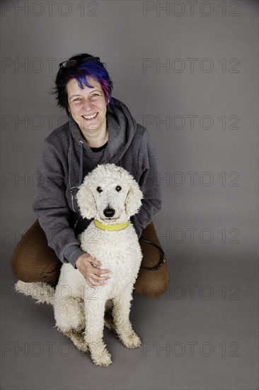 Woman with white king poodle