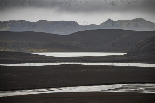 River and lakes in black lava desert