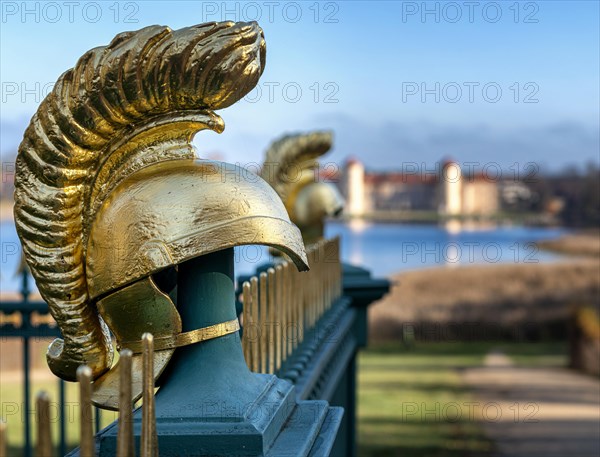 Restored fence with gold helmets at the Lake Grienerick obelisk in Rheinsberg