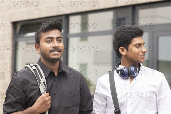 Students outside with bag in front of the university
